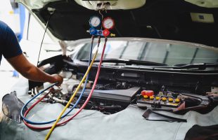 Car air conditioner vacuum down and recharge air conditioning system service.